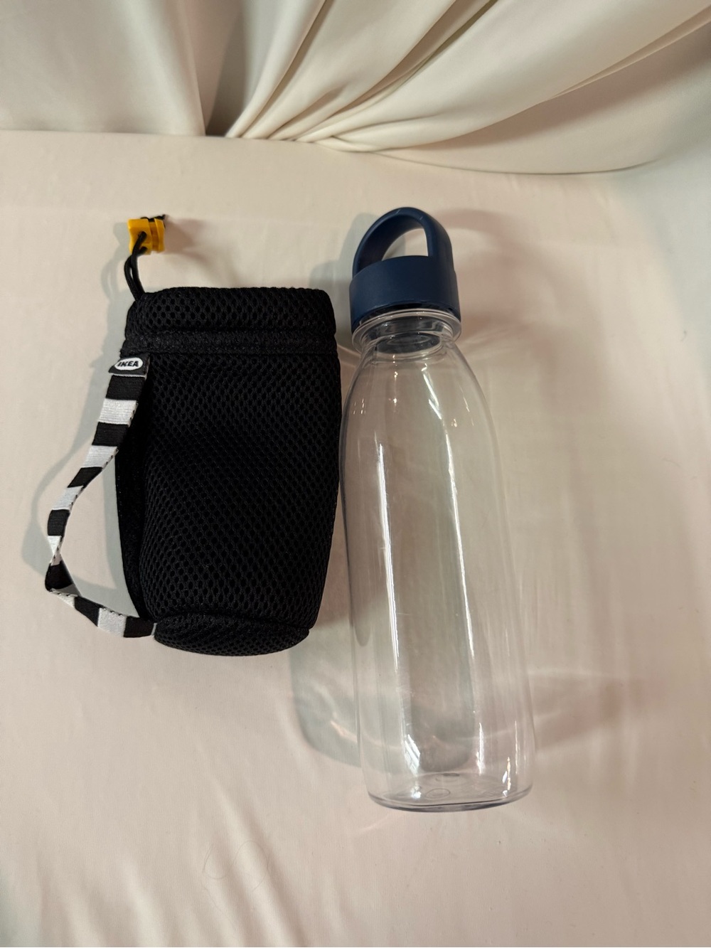 IKEA Clear Water Bottle with Blue Lid and Black Mesh Carrier